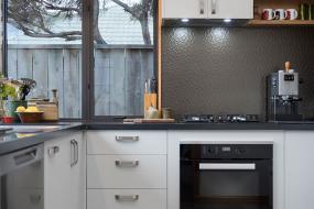 Light grey kitchen with dark benchtop