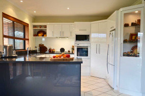 White kitchen with contrasting dark bench