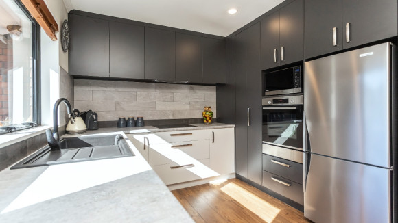 modern kitchen renovation christchurch dark cabinets gray tile backsplash