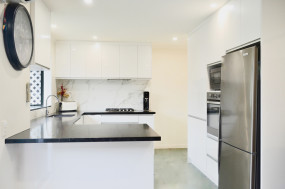 Modern white kitchen with dark benchtop
