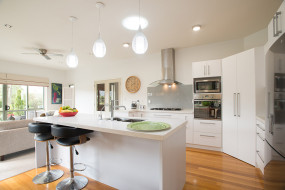 White Open Plan Kitchen with Wooden Floors