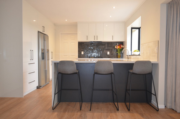 white kitchen feature tiling